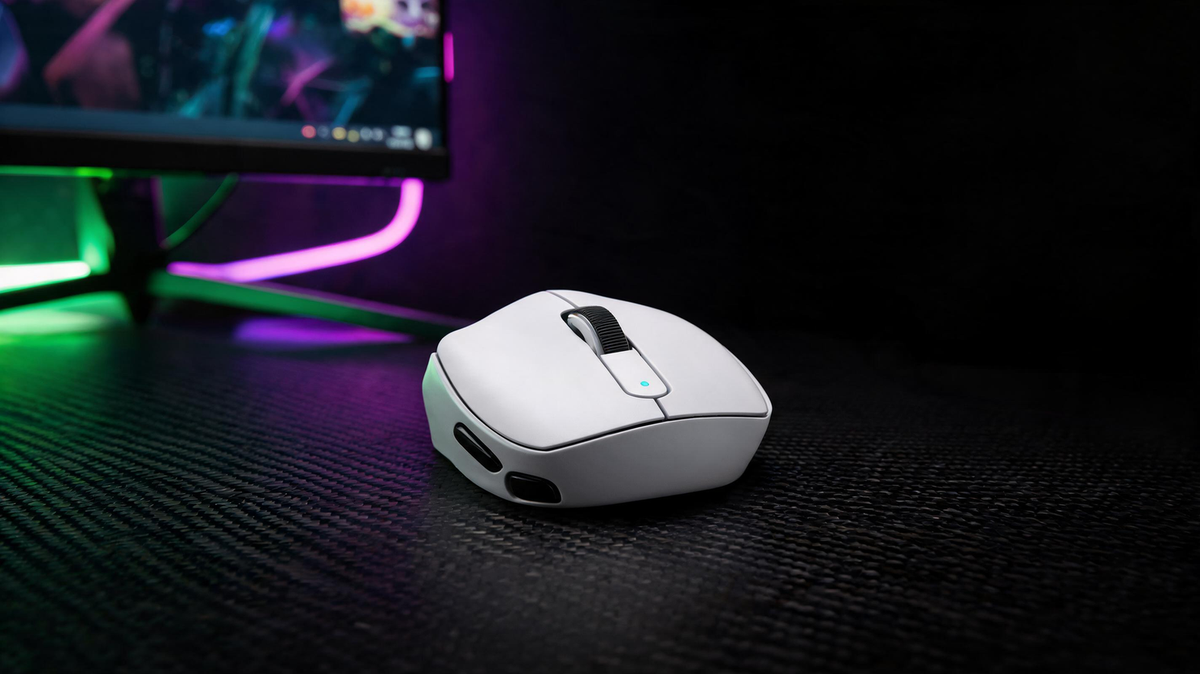 MAMBASNAKE M3 gaming mouse on a neon-lit esports desk beside a gaming monitor