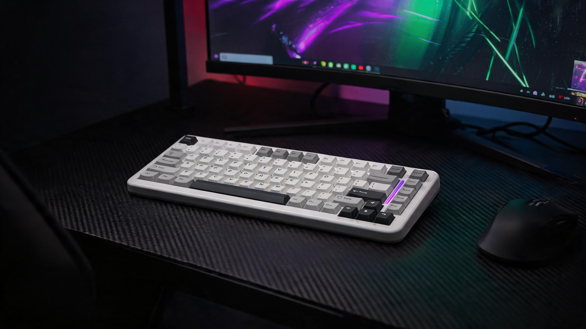 Gaming keyboard arranged on an esports desk beside a monitor in a dark neon-lit room