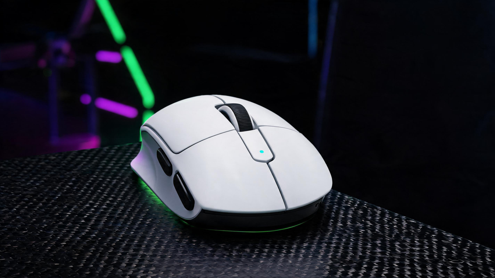 Lightweight gaming mouse on a carbon-fiber desk in a neon-lit gaming room