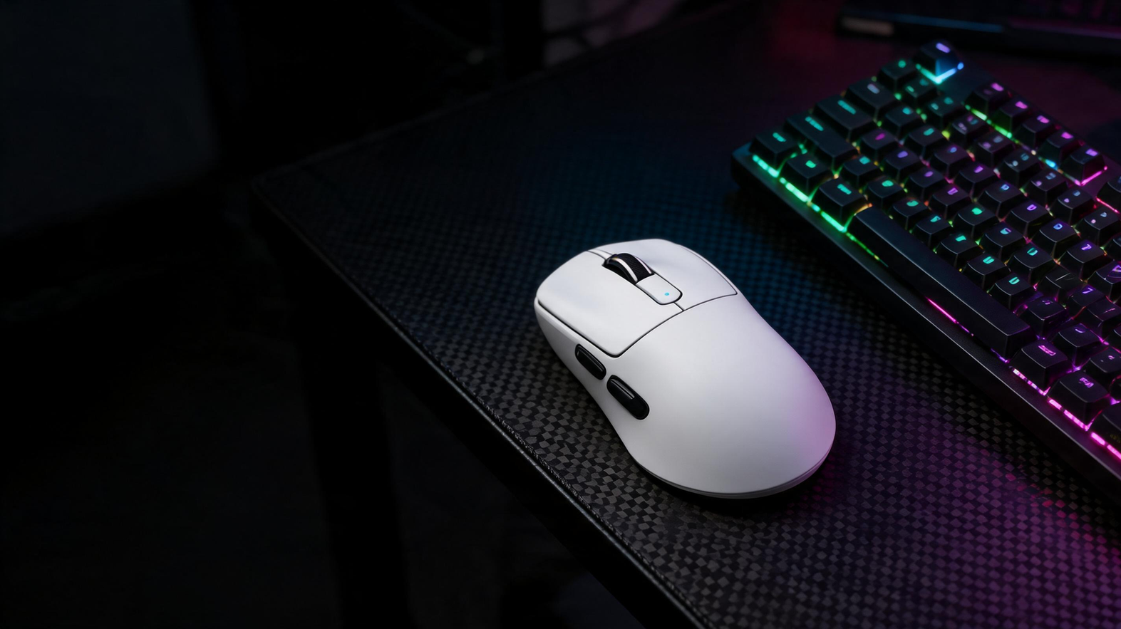 Gaming mouse and keyboard arranged on a carbon-fiber desk beneath green and purple neon lighting