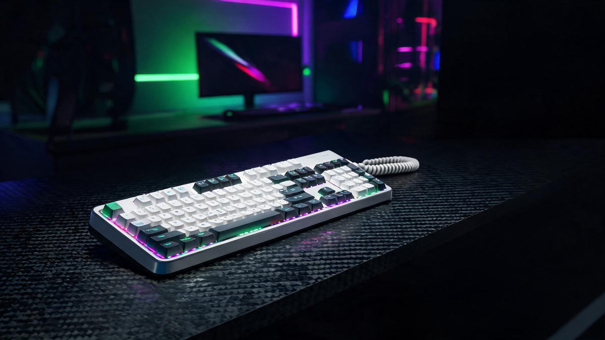 Cute gaming keyboard glowing on a dark RGB-lit gaming desk with room for headline text on one side