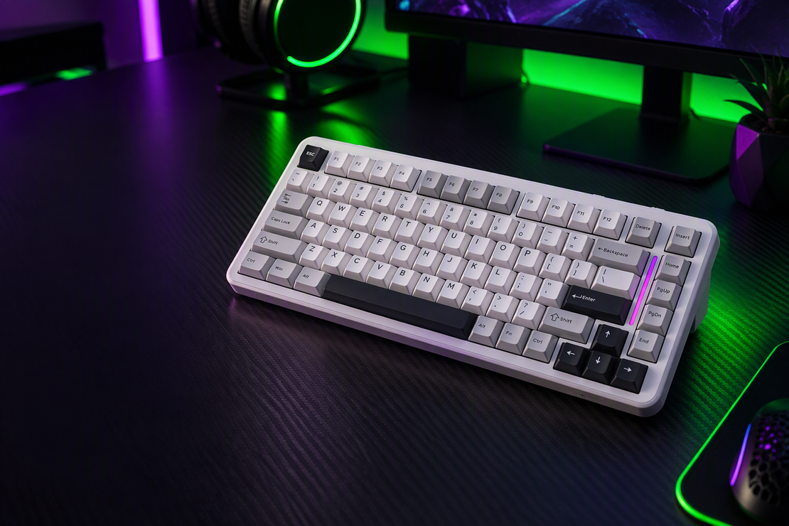 White MAMBASNAKE M82 HE 75% Hall Effect gaming keyboard on a carbon-fiber desk, with neon RGB lighting and dark space at left.