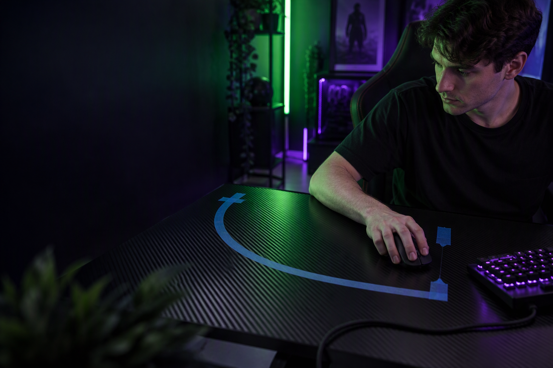 A gamer tests a wide mouse sweep across a carbon-fiber desk marked with painter’s tape in a dark RGB-lit gaming room.