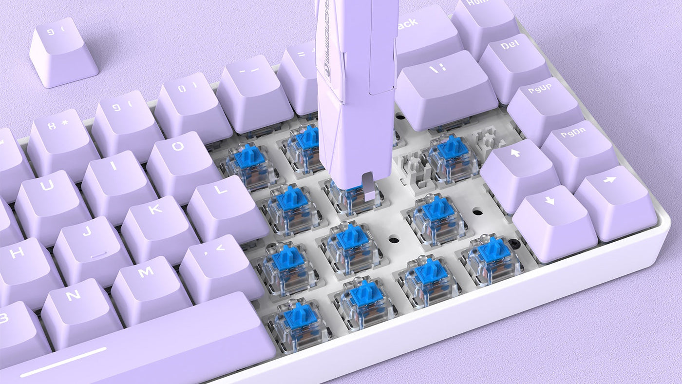 A keycap puller removing a purple keycap from a mechanical keyboard, revealing the blue switch underneath the key