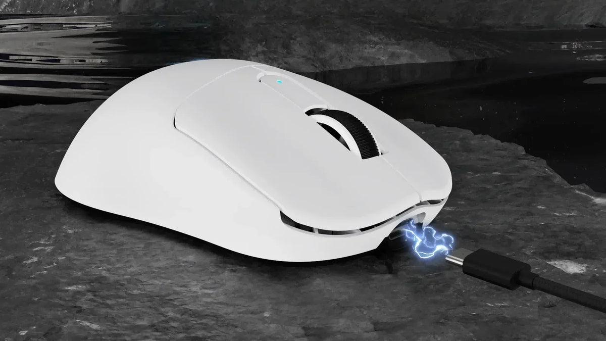White mouse with cable plugged in and blue graphic effect on dark surface