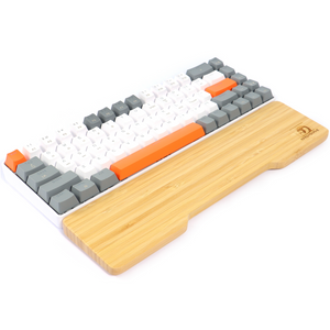Bamboo wrist rest with a white and orange gaming keyboard